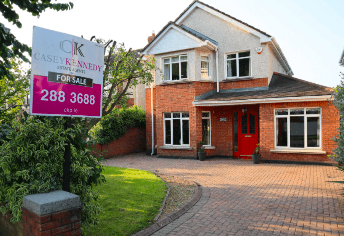 Image of a 2 storey detached house with a Casey Kennedy Auctioneers sign.