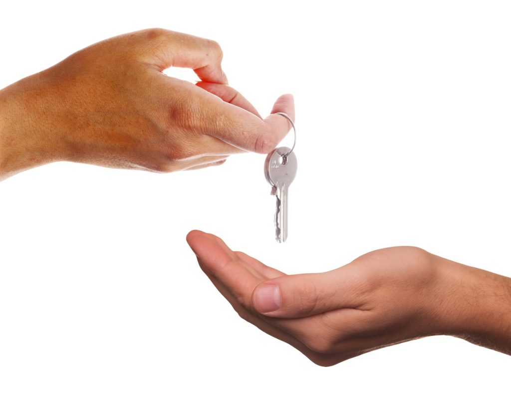 A landlord handing the keys to the property to the tenant whilst informing them of the rights and responsibilities under the tenancy agreement.