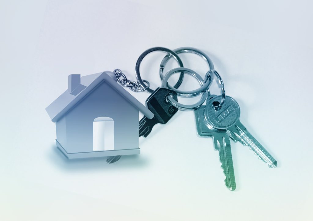 Landlord giving keys to tenant in exchange of residence in the property.